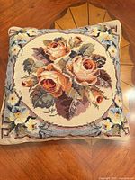 Front view of wool needlepoint pillow showing full floral design