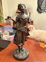 Full-view of bronze statue on table