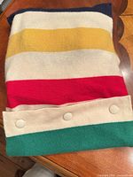 Cashmere multistripe pouch folded with button closure