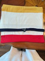 Folded Hudson’s Bay ribbed cashmere shawl showing yellow, cream, navy and red stripes