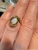 Ring on hand showing overall design and gemstone