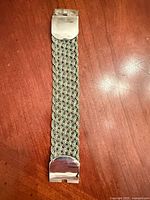 Full bracelet front view showing braid and both clasp ends