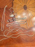 Overview of all necklaces laid out on table