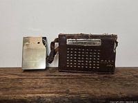 Both pocket radios with MACO leather case