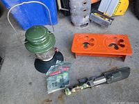 Lantern, two mantle packs, stove base, folding shovel tool overview