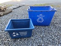 Both recycling bins side by side on gravel, showing size difference and printed graphics