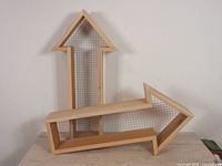 Two cedar arrow shelves showing both orientations and wire mesh backs