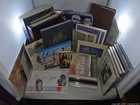 Assorted greeting cards, CDs and books in bin