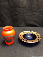 Both items: orange vase and blue dish side by side