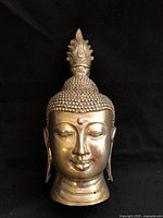 Front view of brass Buddha head bust