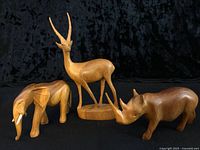 Front view of all three hardwood animal figurines