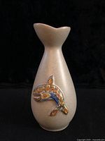 front view of vase showing fish motif and shape