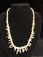 Full view of coral necklace on display bust