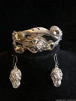 Bracelet displayed on stand with earrings below