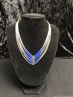 Full view of multi-strand sterling and lapis necklace displayed on bust