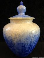 Front view of signed crystalline-glazed lidded pottery vase