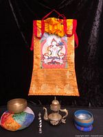 Full lot showing thangka, bowls, teapot, wand