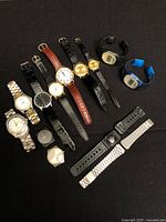 All 11 watches arranged on black background