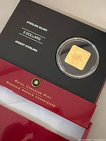 Coin in capsule mounted on display card showing denomination and metal