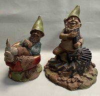 Both Tom Clark gnome figurines side by side for scale and comparison