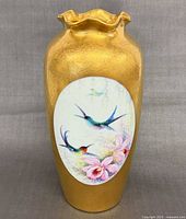 Full view of gold vase with painted reserve