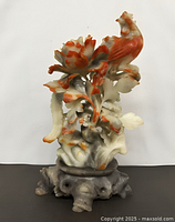 Full view of multicolour soapstone rooster sculpture on pedestal