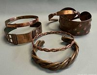 Group shot of all five vintage copper bracelets
