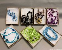 All six necklaces in individual display boxes