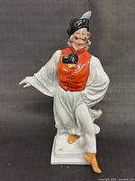 Front view of porcelain folk dancer figurine showing overall pose and colors