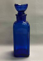 Front view of cobalt blue eye wash bottle