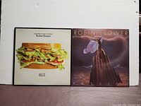 Front covers of both LPs: B.L.T. left, Passion right