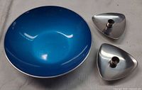 Top view of blue Emalox bowl and two stainless Lundtofte candle holders