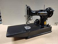 Left side view of Singer Featherweight 221 sewing machine with extension bed down