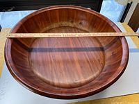 Top view showing interior of round pine baby bath with yardstick for scale