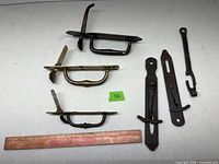 Group view of three door handles and two barn latches on table