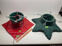 Metal and plastic Christmas tree stands side by side with ruler for scale