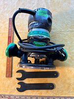Router front view with cord and wrenches