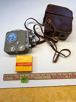 Camera, case, sealed film with ruler for scale