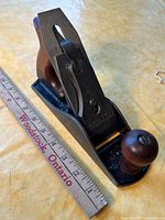 Three-quarter view of assembled Shelton No. 9 bench plane beside ruler