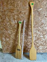 Both paddles side by side with yardstick for scale