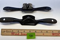 Two spokeshaves laid out with ruler for scale