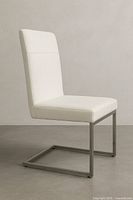 Full side view of chair showing white upholstery and cantilever stainless base