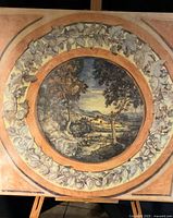 Full view of square panel showing central tondo landscape and surrounding fruit wreath
