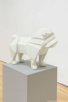 Full view of white geometric bulldog sculpture on pedestal