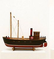 full view of wooden tugboat model on stand