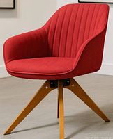 Front angled view of red mid-century chair showing upholstery and legs