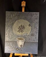 Full view of signed painting on easel