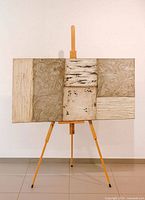 Full view of painting on easel showing horizontal orientation and segmented textures
