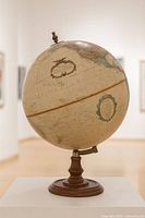 Full view of globe on pedestal stand