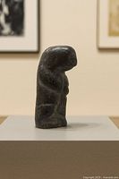 right side view of stone figure showing overall form